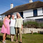 image from the guardian of three white women standing on the lawn of a new home