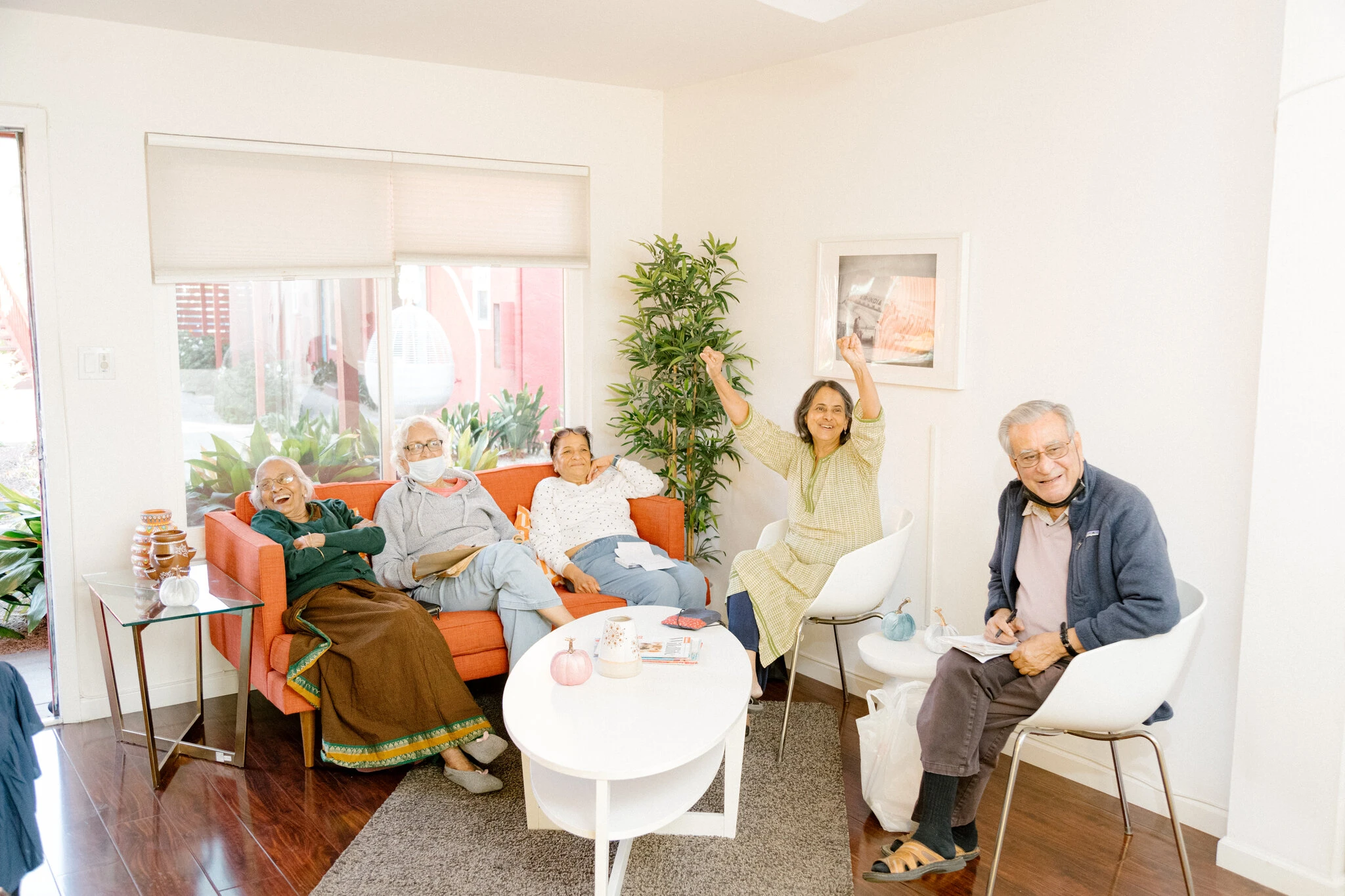 Residents of Priya Living playing a group game of Wordle inside one of the units.